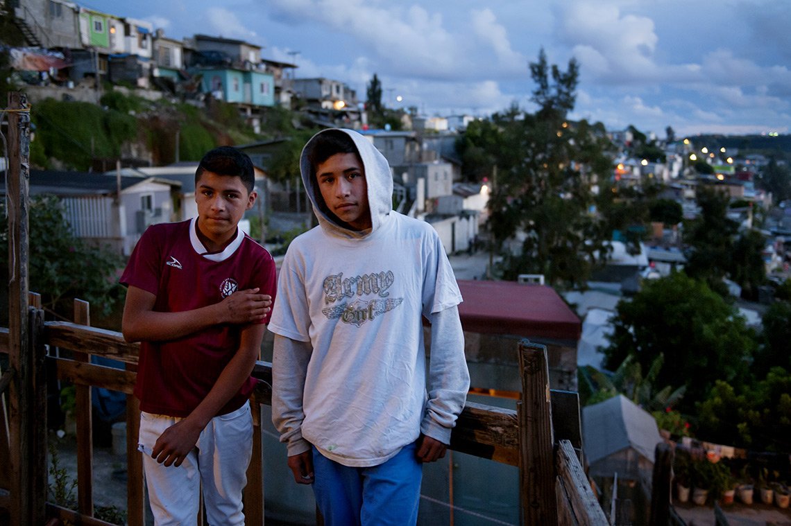 Two teenage boys on a deck in their Tijuana Mexico neighborhood
