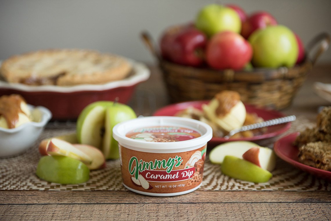 Product photo of Jimmy's Caramel Dip surrounded by apples, ice cream and apple pie.