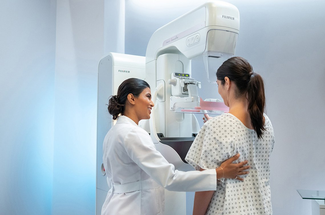 Advertising photo of Fujifilm healthcare worker and woman at mammogram machine