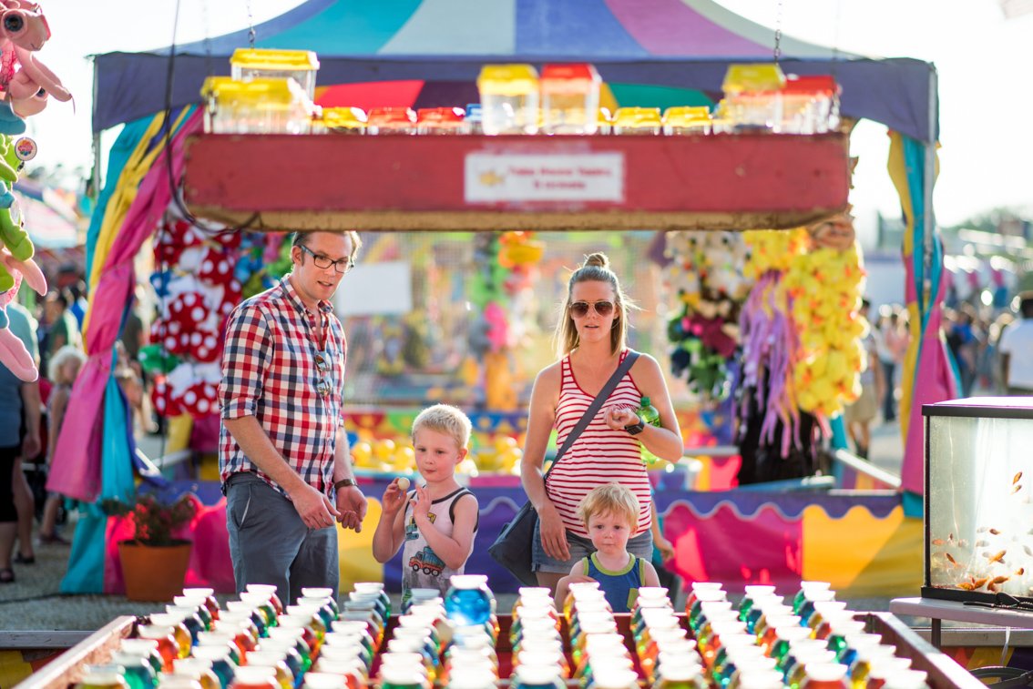 A family plays games at the Olmsted County fair in Rochester MN
